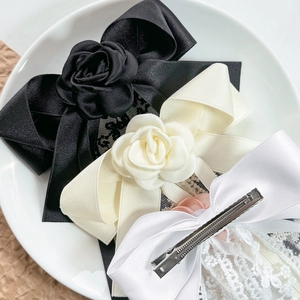 Elegant lace bow hair clips with rose decor in black, cream, and white for women