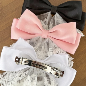 Three-piece lace bow hair clip set in black, pink, and white satin with metal spring clip