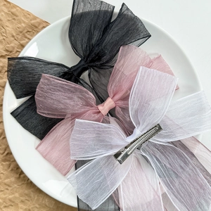 Three-piece set of large sheer organza bow hair clips in black, pink, and white colors
