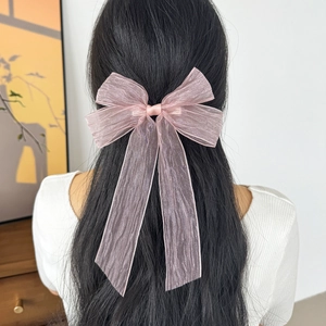 Elegant pink mesh bow hair clip with long tassels worn on long black hair for women