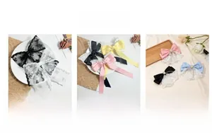 Detail of lace and satin bow hair clips with faux pearl accents in multiple colors