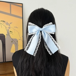 Elegant light blue satin bow hair clip with white lace trim for stylish half-up hairstyles