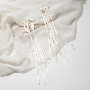 Detail of sweet cream bow hair clips with silk ribbons, faux pearls and colorful gems