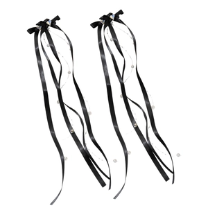 Pair of black satin bow hair clips with heart crystals and beaded ribbons for styling