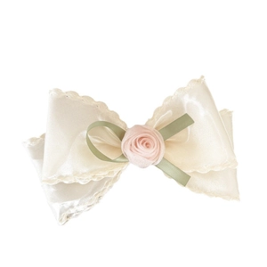 Elegant cream satin bow hair clip with pink fabric rose and green ribbon detail