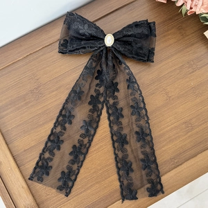 Elegant black lace bow hair clip with pearl center and streamers for women
