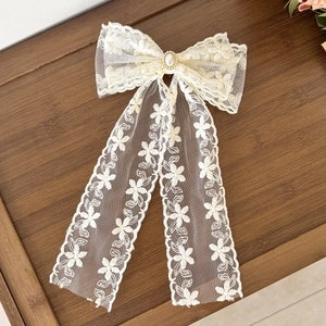 Elegant cream lace bow hair clip with faux pearl and floral embroidery detail