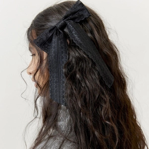 Elegant large black lace bow hair clip for women, vintage style accessory on model hair