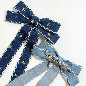 Vintage denim bow hair clips with star embroidery and long ribbons in blue tones
