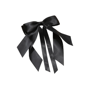 Elegant black satin bow hair clip with long ribbons featuring a silky lustrous finish