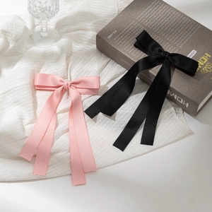Elegant satin bow hair clip with long ribbon streamers in pink and black colors