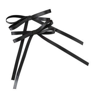Elegant pair of black satin bow hair clips with long ribbon streamers for women