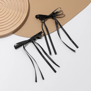 Set of two black satin ribbon bow hair clips with long streamers for elegant styling