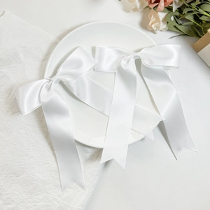 Pair of elegant white satin ballet-style bow hair clips with long streaming ribbons
