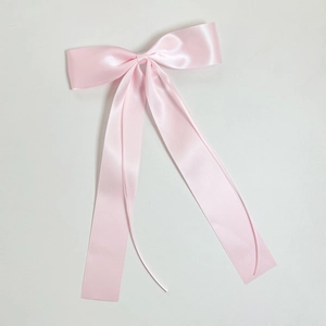 Elegant pink satin ribbon bow hair clip with long streamers for a graceful look
