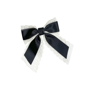 Elegant black silk satin bow hair clip with white lace trim and spring fastener