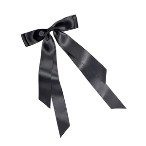 Elegant black satin bow hair clip with long silk ribbons for women's hair styling