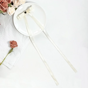 Elegant cream white bow hair clip with black heart jewel and long lace ribbon tassels