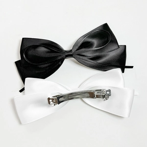 Elegant set of black and white satin bow hair clips with silver spring fasteners