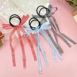 Three ballet-style plaid bow hair ties with long ribbons in red, blue and black