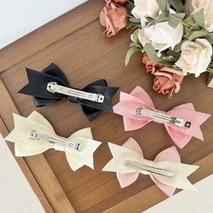 Elegant four-piece satin bow hair clip set with metal spring clips in assorted colors