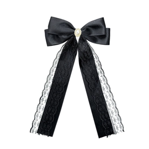 Elegant black satin bow hair clip with lace streamers and a central faux pearl accent