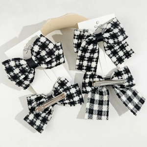 Classic black and white houndstooth bow hair clips set with silver metal duckbill clips