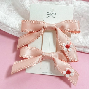 Pink ribbon bow hair clips with white floral embroidery for women and girls