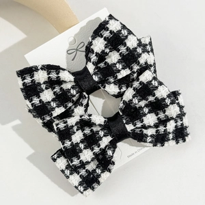 Classic houndstooth bow hair clips with black satin ribbon on a white card