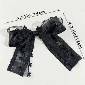 Detail of black satin bow hair clip with heart lace trim and size labels shown