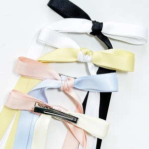 Satin silk bow hair clips in assorted pastel colors on a clean white background