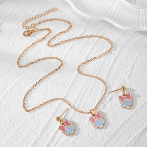 Set gioielli mummia dorata con collana e orecchini con teschio blu e fiocco rosa
