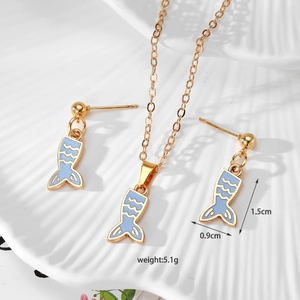 Detail showing dimensions of blue fishtail pendant earrings and necklace set on shell tray