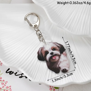 Detailed close-up of acrylic Shihtzu dog keychain with metal clasp on decorative shell tray