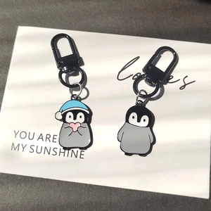 Creative penguin alloy keychain set with blue sleeping hat and pink heart charm