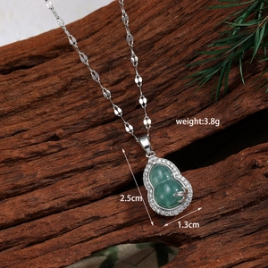 Detailed view of gourd pendant with green agate stone and white zircons on silver chain