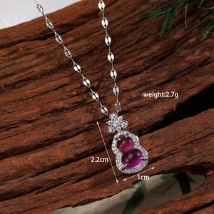 Macro shot of silver gourd pendant with purple stones on vintage wood background