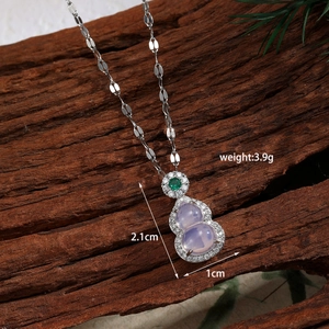 Detail of a gourd pendant with purple stones and green zircon on a flat link chain