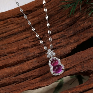 Macro detail of calabash purple gemstone pendant with zircon inlay on silver chain