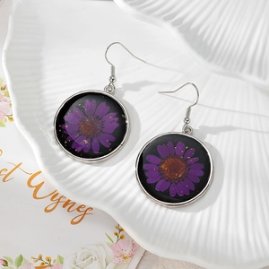 Round resin drop earrings with purple dried daisy flower and gold foil on white ceramic