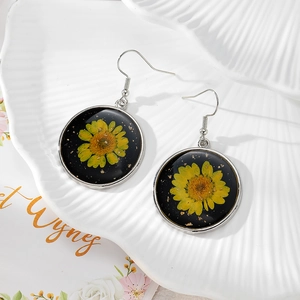 Daisy dried flower earrings in black resin with gold foil and silver hooks