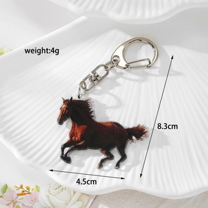 Detail of creative double-sided acrylic horse keychain on a white decorative shell plate