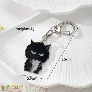 Detail view of a black cat acrylic keychain with dimensions 8.5cm by 2.9cm and metal D-ring