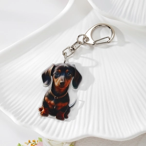 Creative double-sided acrylic dachshund keychain with silver metal ring on white tray