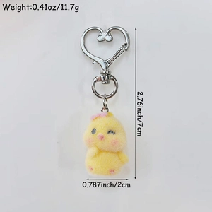 Yellow flocked chick keychain with pink bow and heart-shaped clip on white background