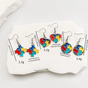 Macro view of colorful enamel puzzle earrings in heart and round shapes with dimensions