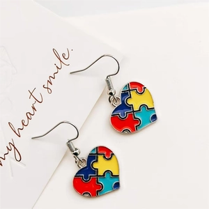 Colorful heart-shaped puzzle piece earrings for autism awareness with silver hooks