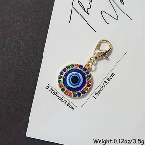 Colorful rhinestone evil eye keychain with gold lobster clasp on thank you card