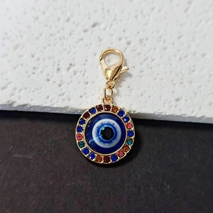 Detail of evil eye pendant with colorful rhinestones and gold lobster clasp