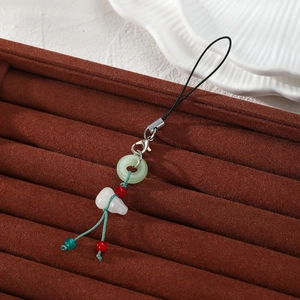 Chinese style phone charm with green jade ring and white gourd pendant on velvet